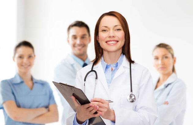 Smiling Female Doctor With Clipboard